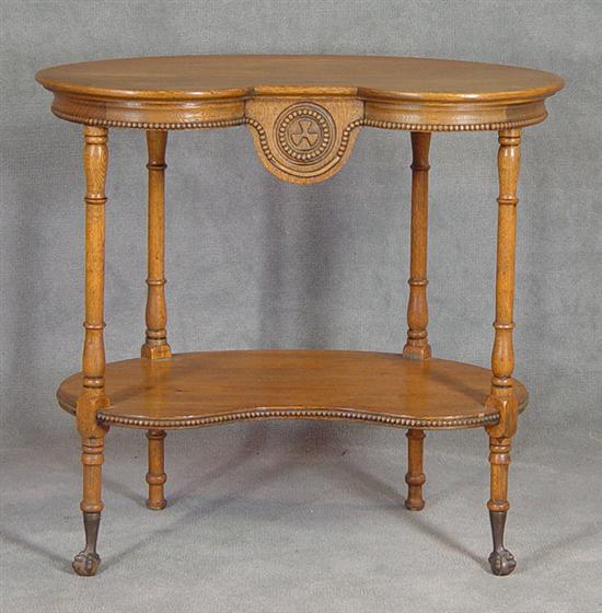 Appraisal: Golden Oak Kidney Table Circa Sculptural top skirt and bottom