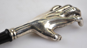 Appraisal: A back-scratcher with cast silver hand on long ebony handle