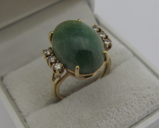 Appraisal: GREEN JADE DIAMOND AND K GOLD RING set with an