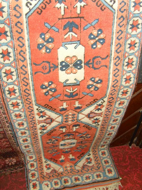 Appraisal: An eastern wool runner with repeating decoration in terracotta blue