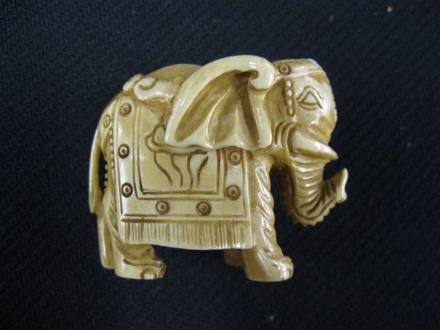 Appraisal: Carved Ivory Netsuke of an Elephant in parade dress signed