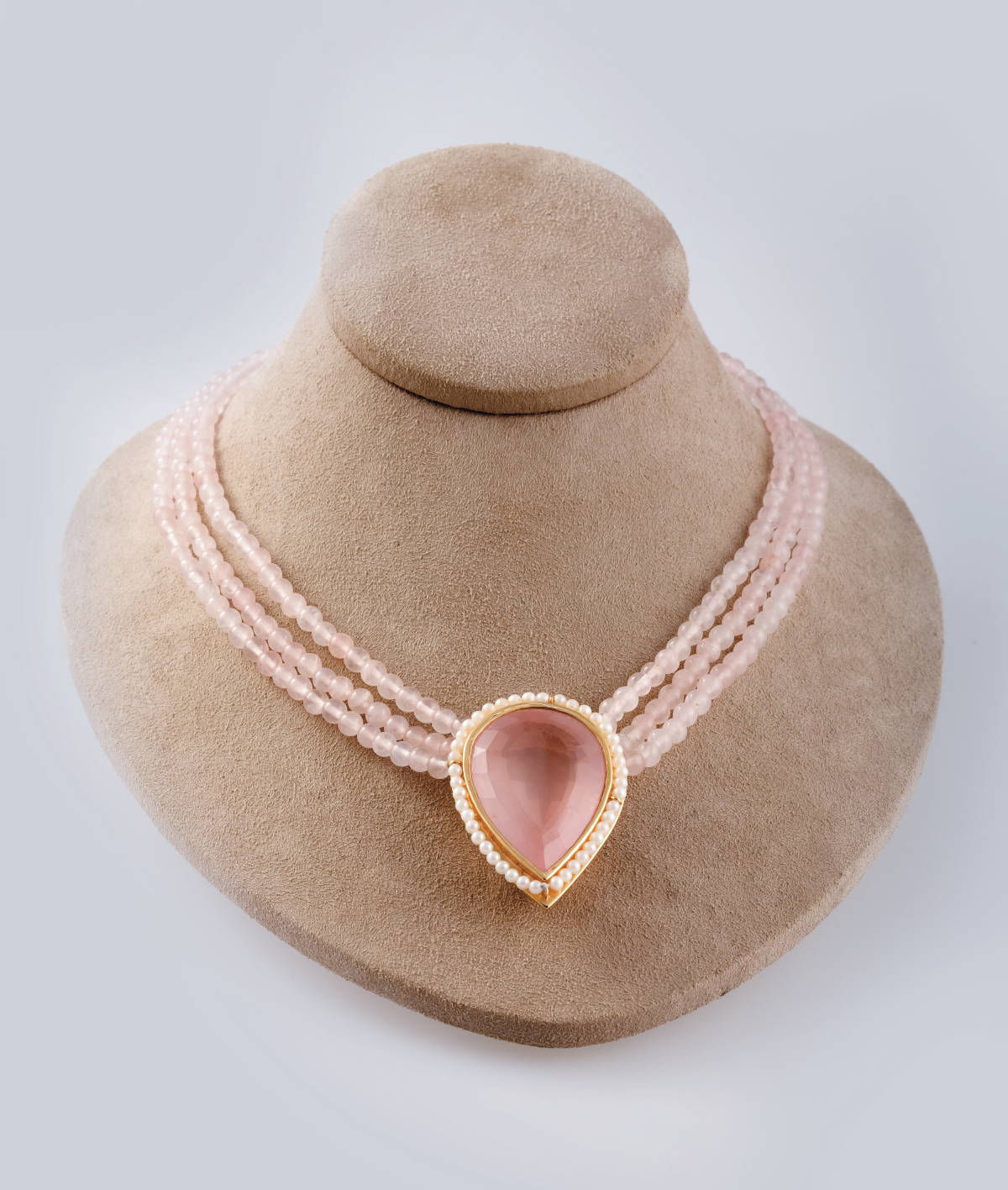 Appraisal: ROSE QUARTZ AND GOLD NECKLACE Three strands of beads centering