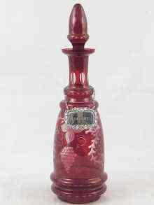 Appraisal: A ruby flashed glass decanter facet cut and wheel engraved