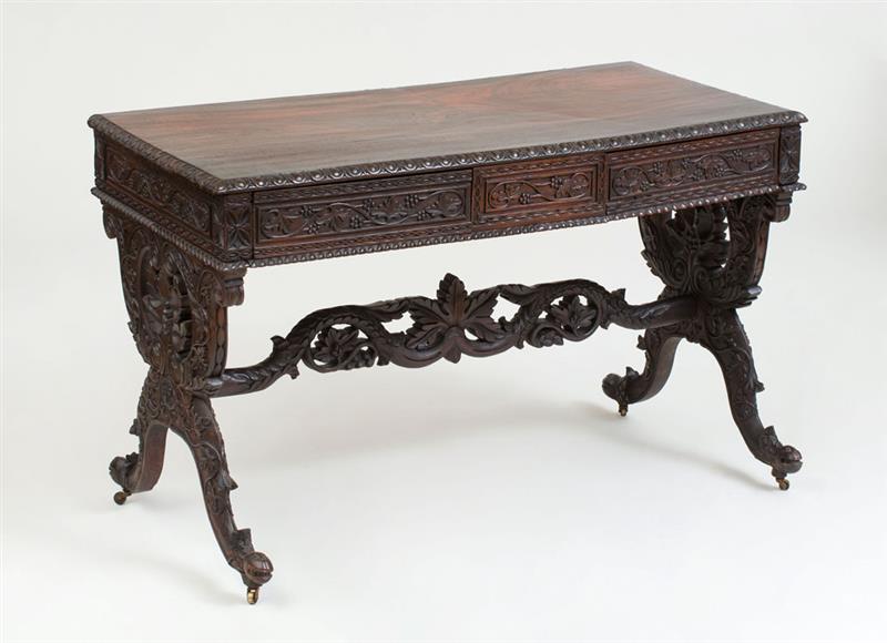 Appraisal: COLONIAL INDO-PORTUGUESE CARVED ROSEWOOD TABLE Fitted with two frieze drawers