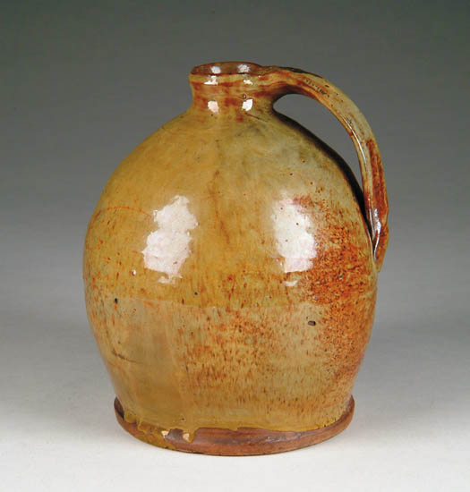 Appraisal: FINE REDWARE SMALL HANDLED JUG Good green glaze with orange