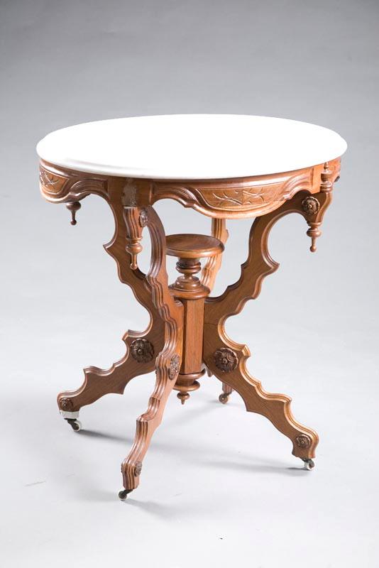 Appraisal: VICTORIAN LAMP TABLE Walnut with a carved apron shaped legs