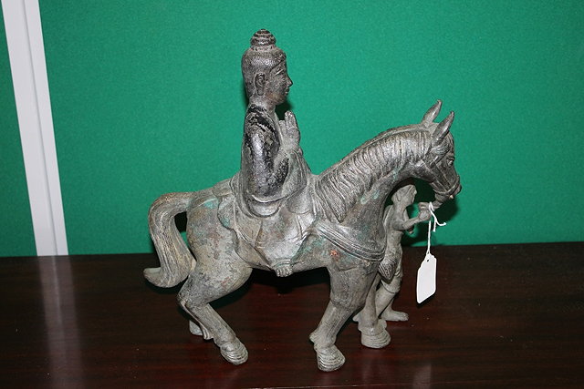 Appraisal: A CHINESE BRONZE BUDDHA being led upon a horse cm