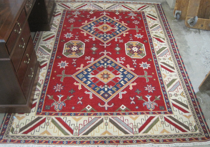 Appraisal: HAND KNOTTED ORIENTAL CARPET Caucasian geometric two-medallion design on red