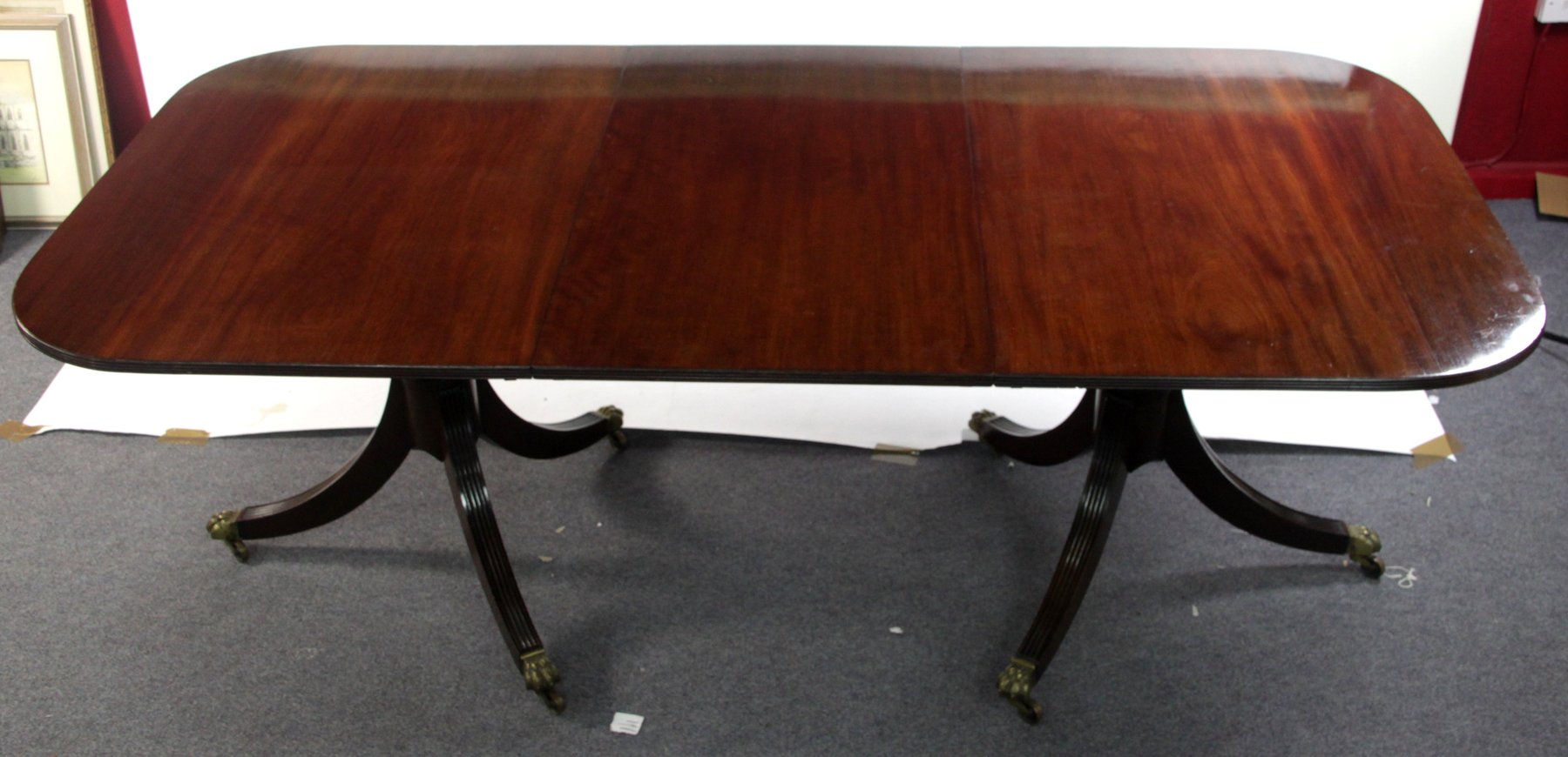 Appraisal: A George III style mahogany two-pillar dining table on gun