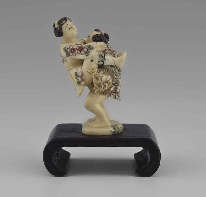 Appraisal: JAPANESE CARVED IVORY EROTIC FIGURAL GROUP Miniature male and female