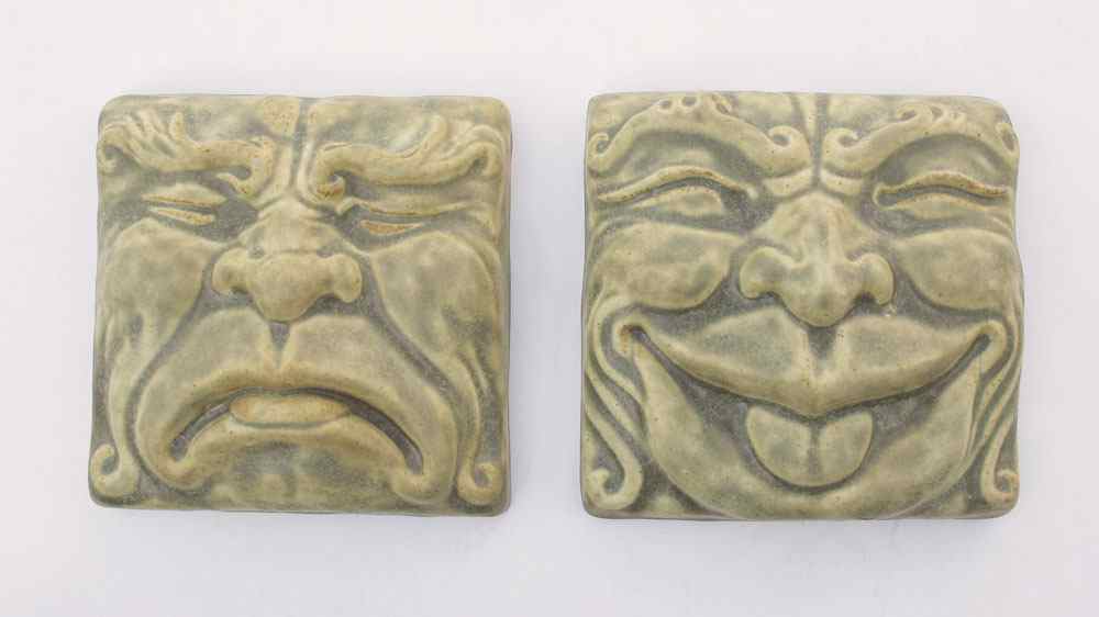 Appraisal: PEWABIC POTTERY COMEDY AND TRAGEDY TILES High relief design by