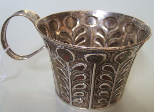 Appraisal: A silver mug decorated with stylized foliate bands in the