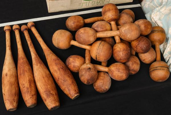 Appraisal: EARLY TH CENTURY INDIAN CLUBS AND DUMBBELLSThe collection as shown