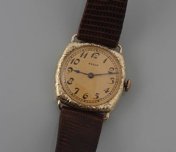 Appraisal: A k gold engraved cushion form lady's leather strapped wristwatch