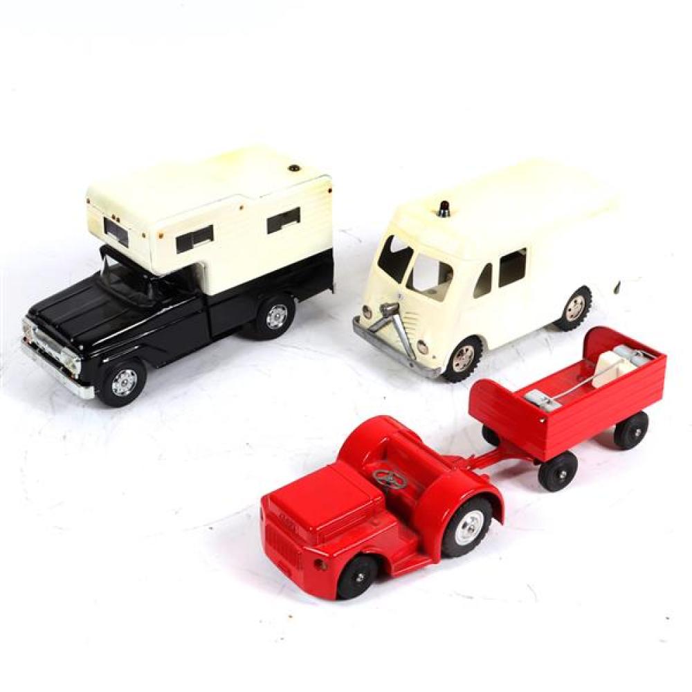 Appraisal: THREE PRESSED STEEL TOY TRUCKS TONKA AIRPORT TRACTOR WITH LUGGAGE