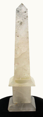 Appraisal: A NATURAL ROCK CRYSTAL SCULPTED OBELISK The natural stone imbedded