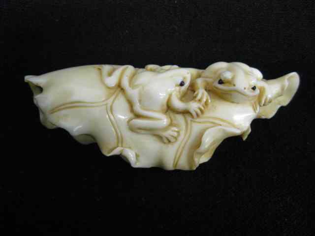 Appraisal: Carved Ivory Figurine of Frogs with a Lotusblossom two on