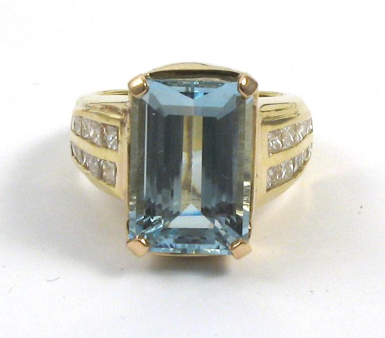 Appraisal: AQUAMARINE AND EIGHTEEN KARAT GOLD RING centering an emerald-cut aquamarine