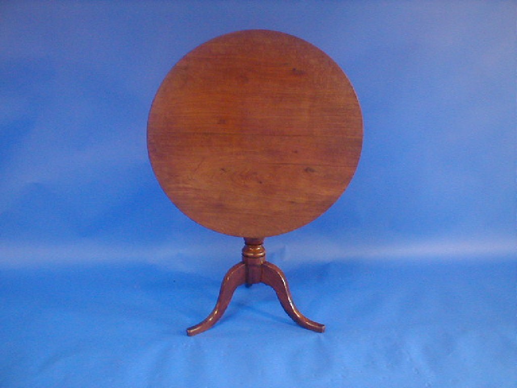 Appraisal: A Georgian fruitwood supper table with circular tilt top turned