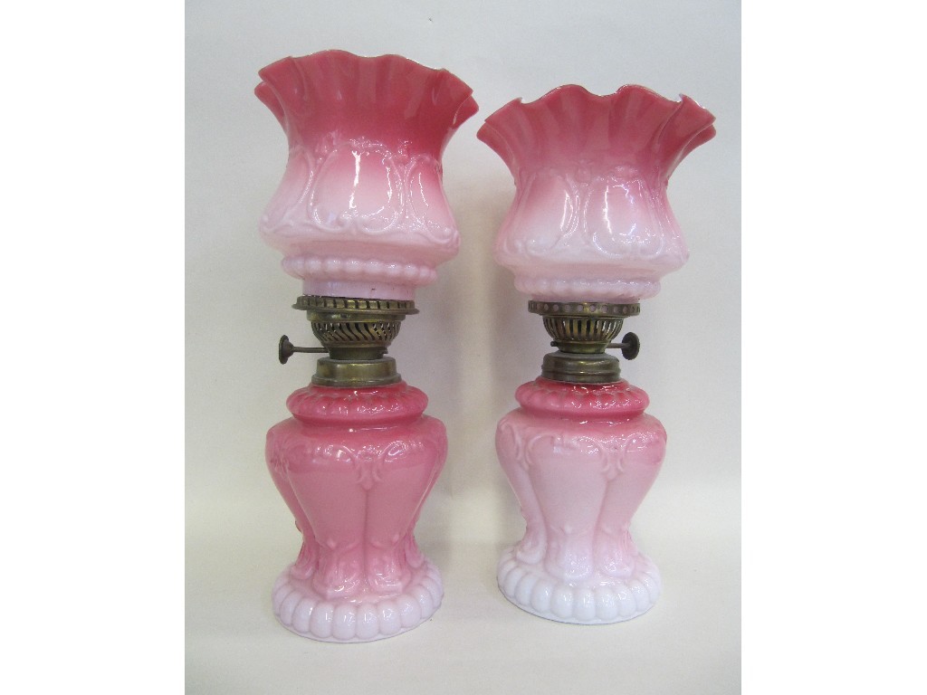 Appraisal: Pair of pink white glasses oil lamps