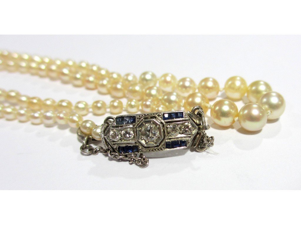 Appraisal: An early th century string of graduated cultured pearls of