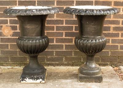 Appraisal: A pair of black painted cast iron campana urns cm