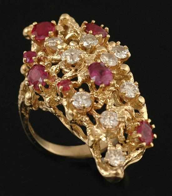 Appraisal: A ruby and diamond cocktail ring Of abstract design randomly