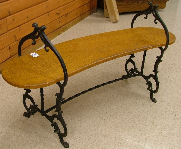 Appraisal: AN OAK AND CAST IRON BENCH American c the curved