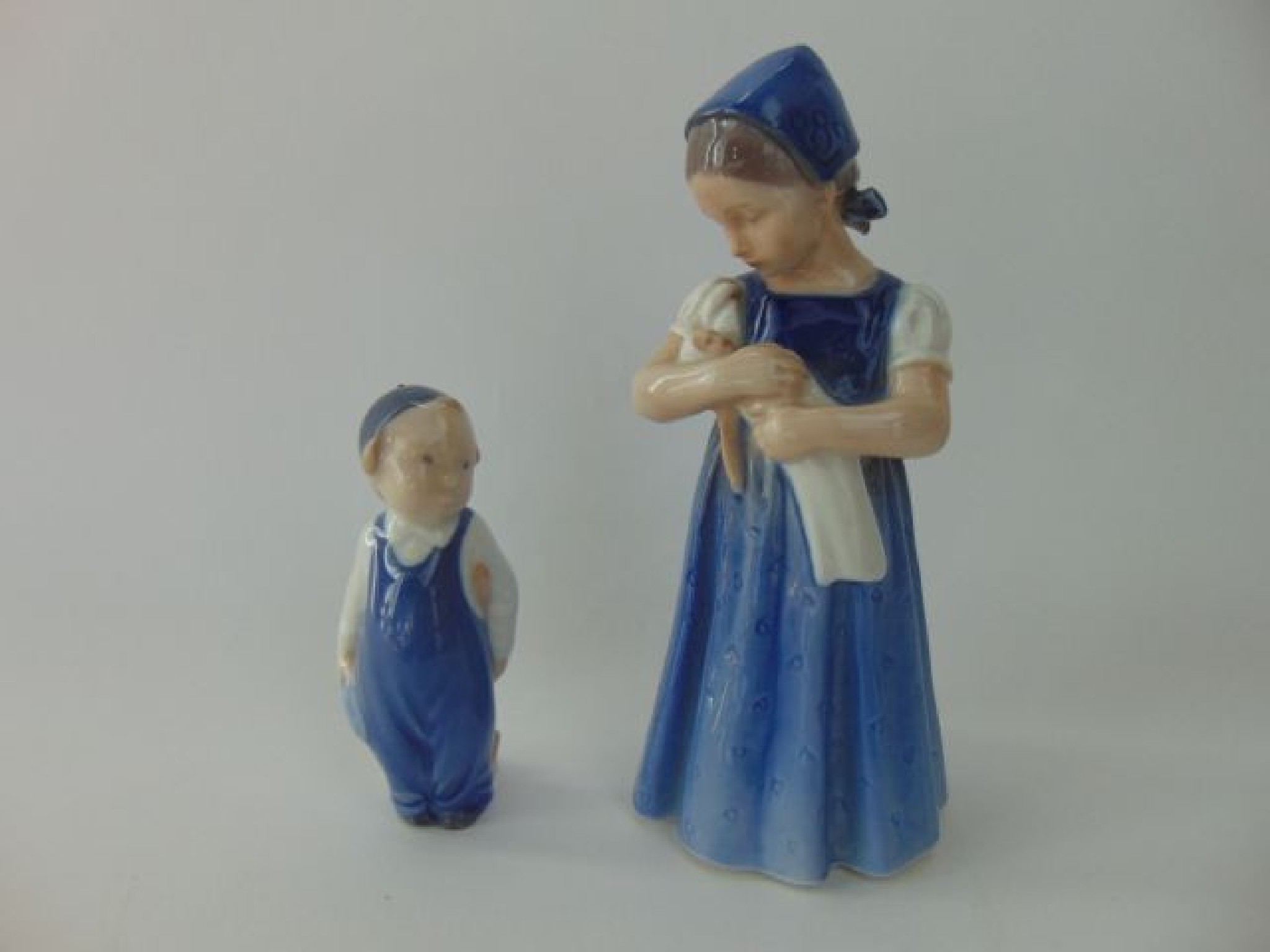 Appraisal: A Royal Copenhagen model of a little girl holding a