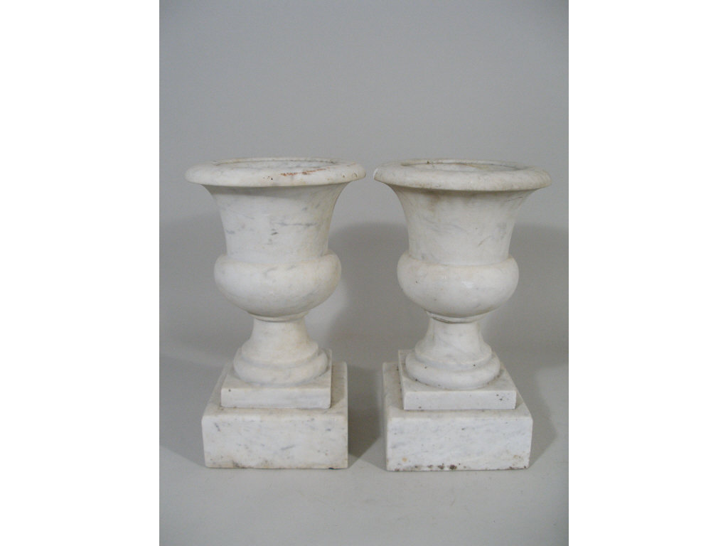 Appraisal: Pair of Marble Garden Urns raised on stepped square plinths