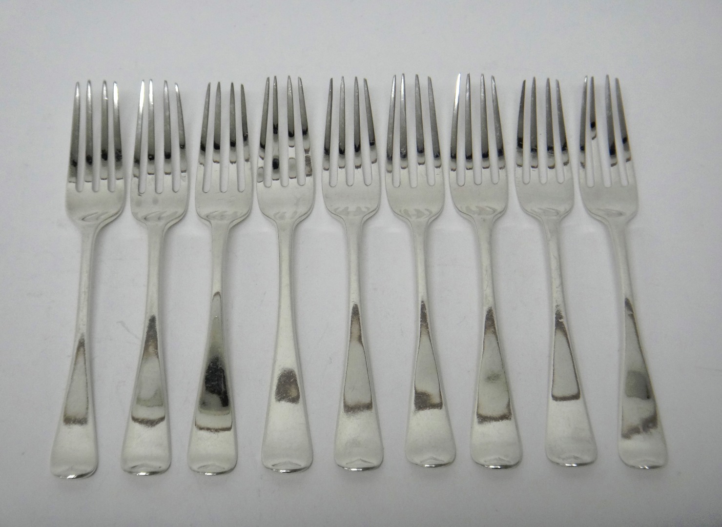 Appraisal: Nine silver Old English pattern dessert forks each crest engraved