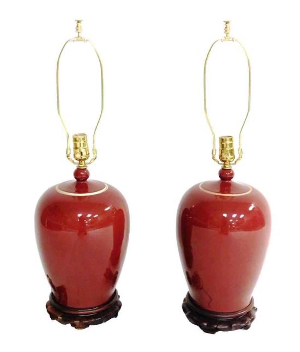 Appraisal: ASIAN Pair of Chinese oxblood glazed porcelain lidded jars mounted