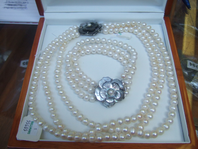 Appraisal: A three row necklace of freshwater cultured pearls on a