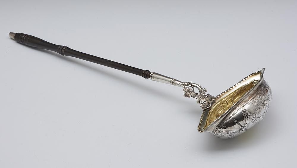 Appraisal: th C Edinburgh silver ladle with angel swags grape motif