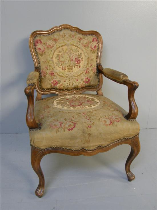 Appraisal: French style walnut framed upholstered armchair with carved shaped back