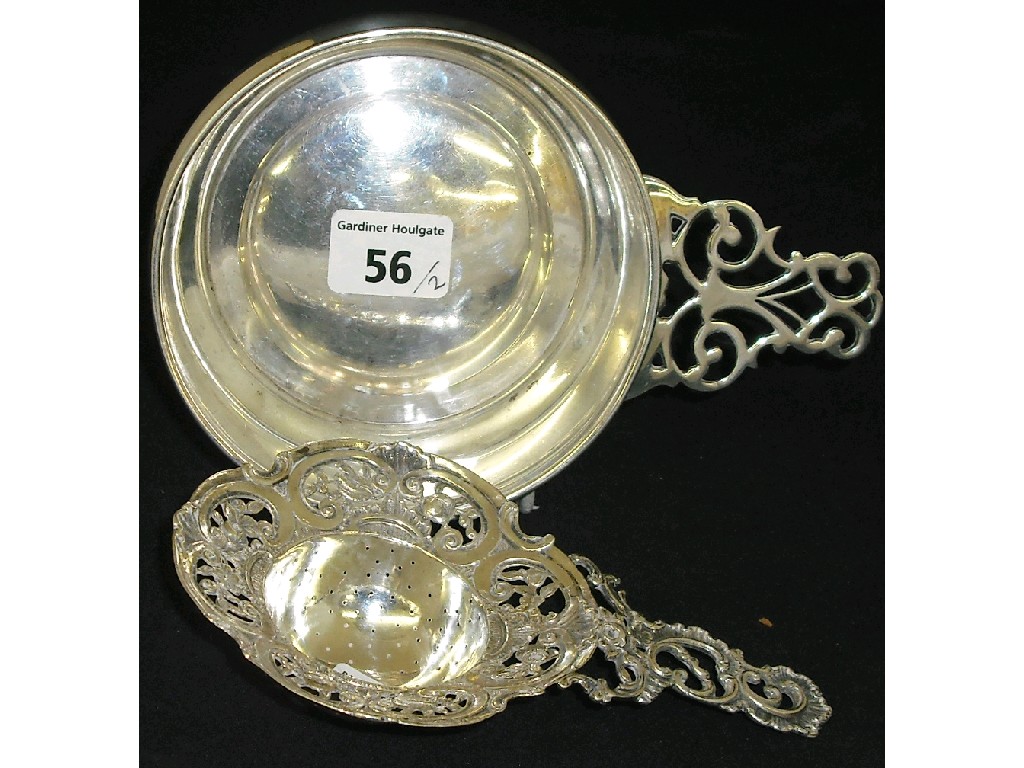 Appraisal: Continental silver porringer with a pierced scroll handle diameter together