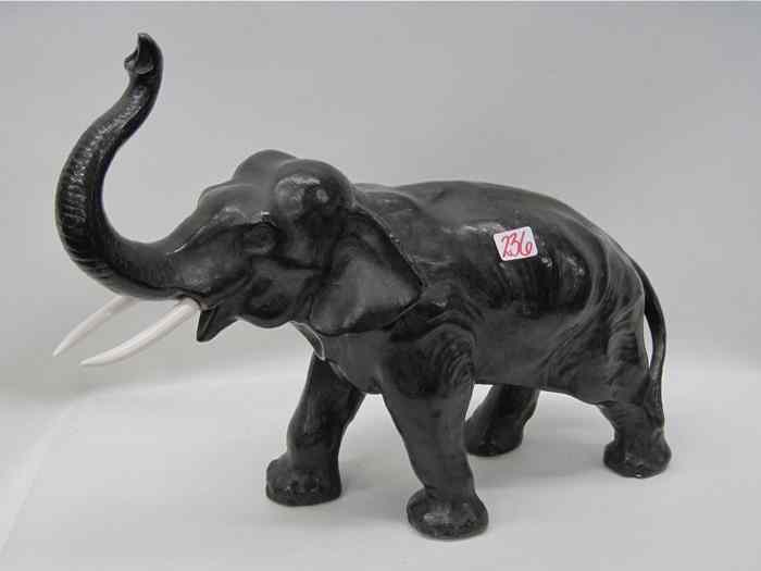 Appraisal: BRONZED SPELTER ELEPHANT SCULPTURE patinated dark brown with bone tusks