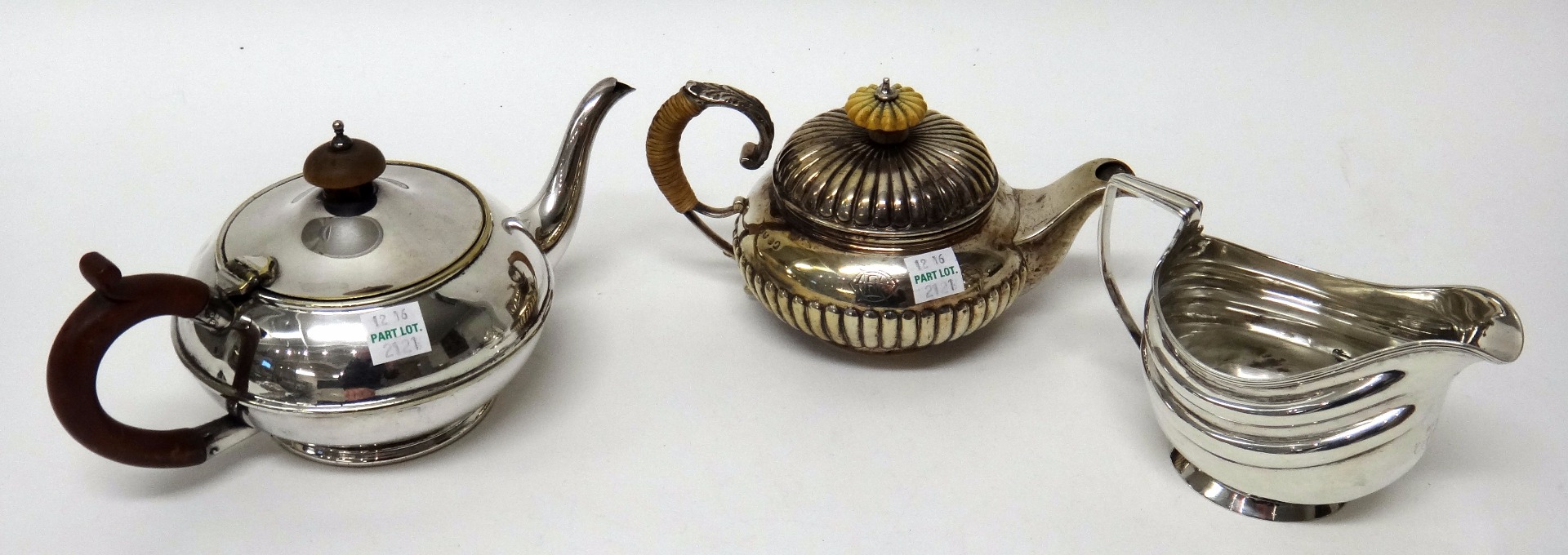 Appraisal: A silver small teapot of circular form with fluted decoration