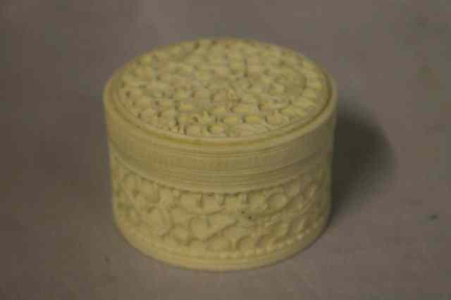 Appraisal: A CHINESE CARVED IVORY CYLINDRICAL BOX the cover decorated with