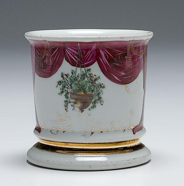 Appraisal: SHAVING MUG WITH HANGING FLOWERS AND CURTAINS porcelain uniquely decorated