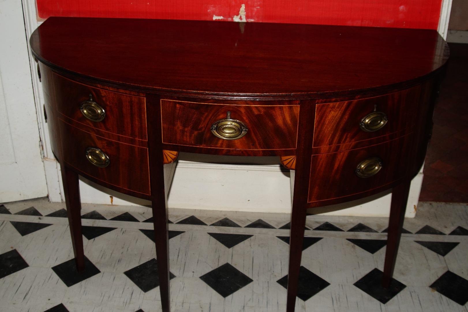 Appraisal: A George III mahogany demi-lune sideboard with three deep frieze