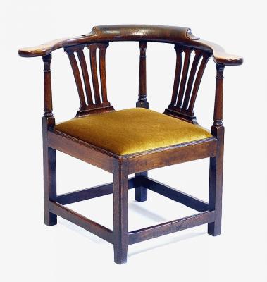 Appraisal: A GEORGE III MAHOGANY CORNER CHAIR the scrolled bow rail