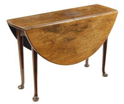 Appraisal: A George II mahogany drop-leaf table the oval top on