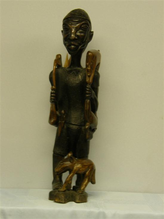 Appraisal: African indigenous wood carved figure holding a bow an animal