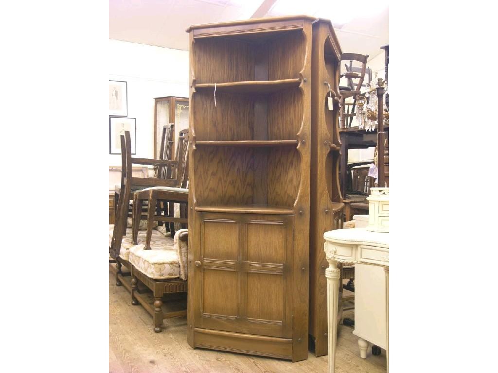 Appraisal: An Ercol medium elm floor-standing corner unit two open shelves