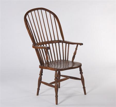 Appraisal: A th century elm Windsor chair the arched top-rail over