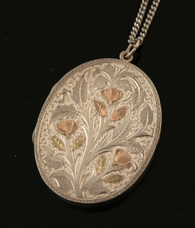 Appraisal: An Antique sterling silver locket and chain The oval sterling