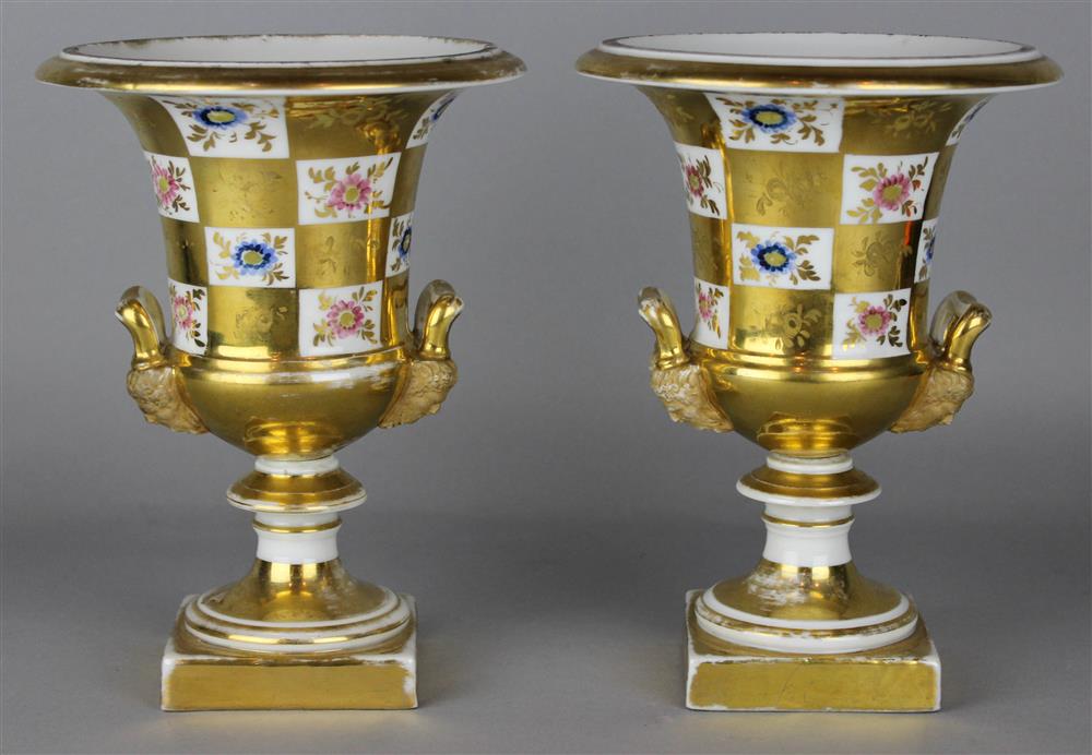 Appraisal: PAIR OF CONTINENTAL PORCELAIN CAMPANA VASES with upright handles mask