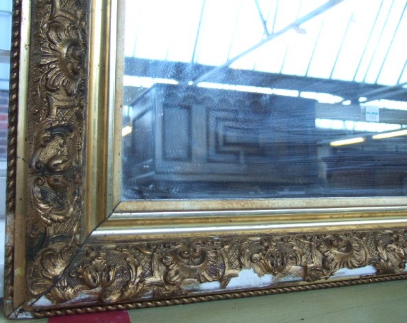 Appraisal: A large th century gilt framed wall mirror of rectangular