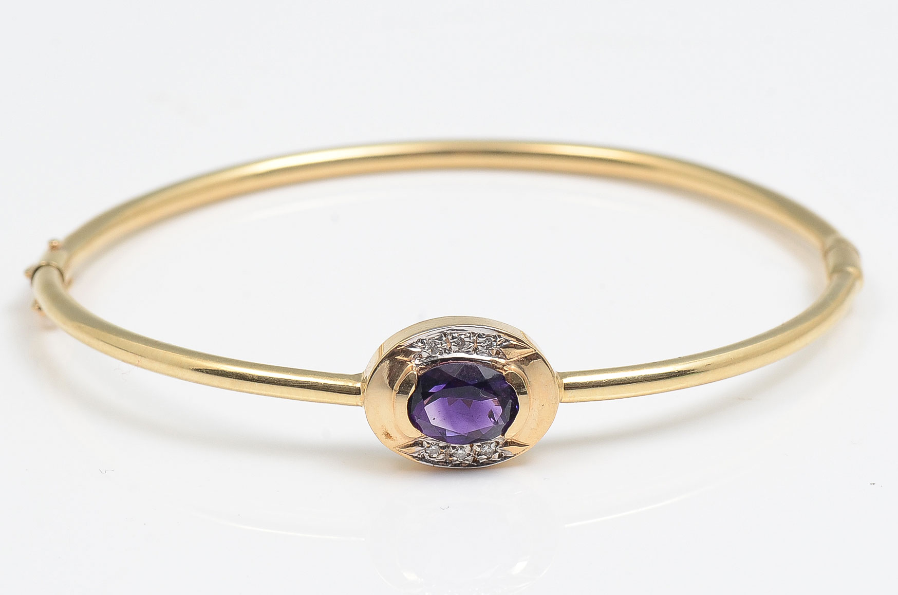 Appraisal: K AMETHYST DIAMOND BANGLE K yellow gold bangle is mounted